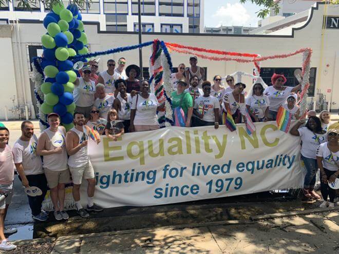 People holding up banner from Equality North Carolina