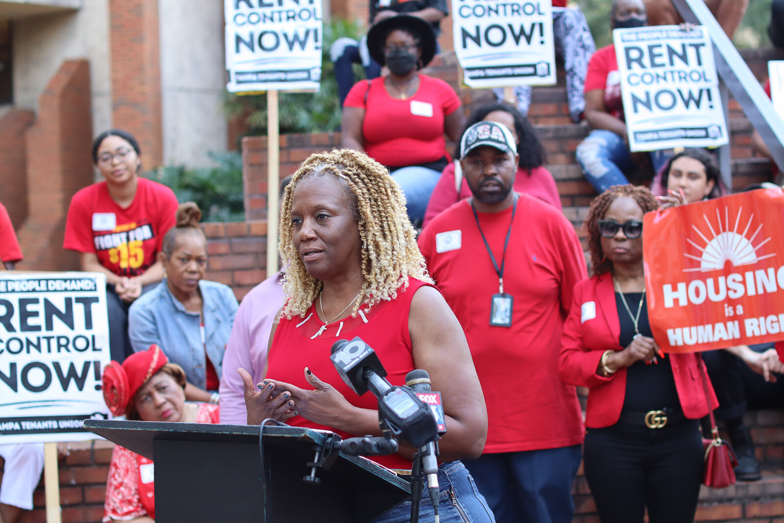 A woman and child hold protest signs about immigration, including 